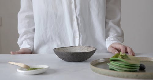 A Person Whisking Matcha in a Bowl