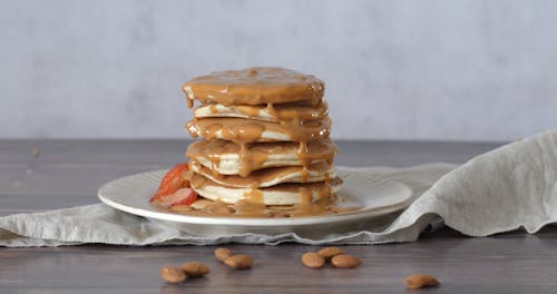 Pile of Pancake with Caramel and Strawberry on the Top