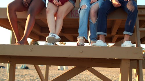 Group of Friends Sitting at the Lifeguard Tower