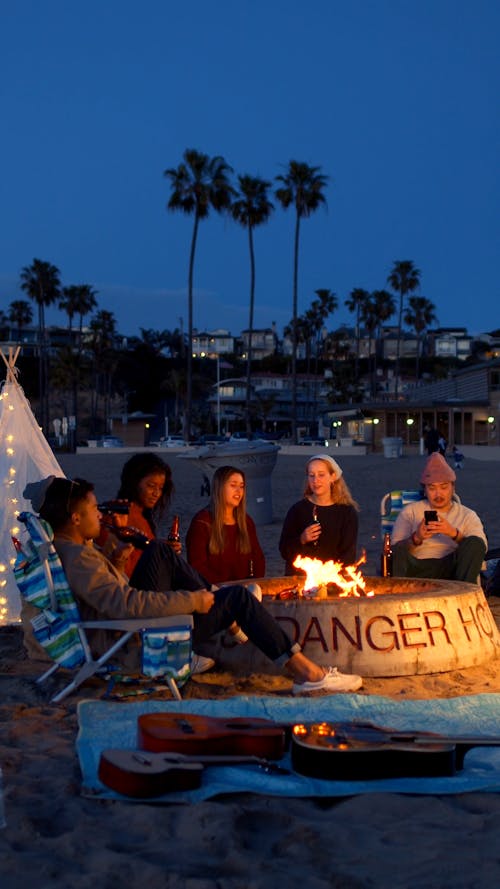 Group of Friends Enjoying Bonfire on Beach