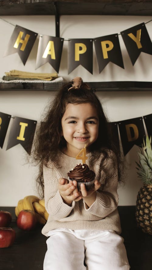 Birthday Girl Holding a Cupcake