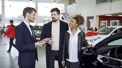 Diverse Couple Talking to a Car Dealer