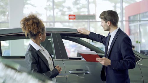 A Woman Having a Chat with a Car Dealer