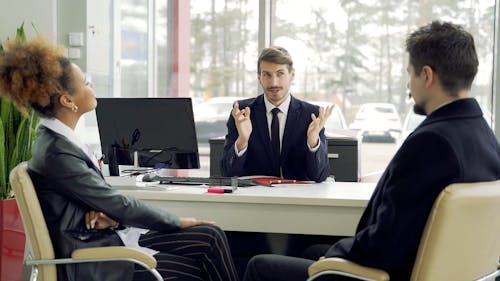 Couple Talking to a Car Agent