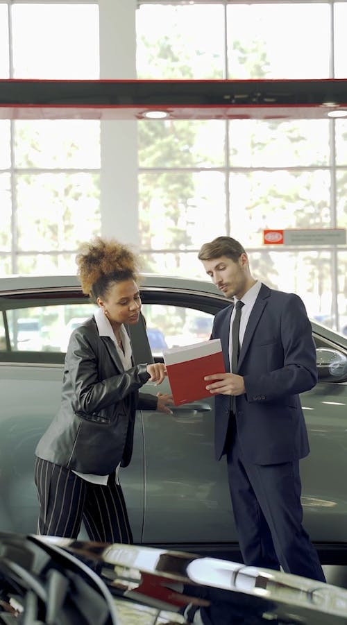 Woman Negotiating Car With A Dealer