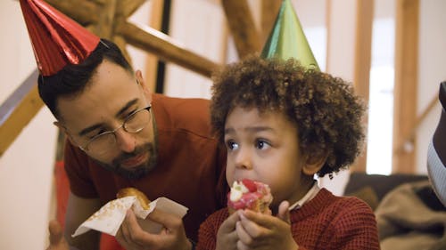 Father and Son Eating Donuts Together