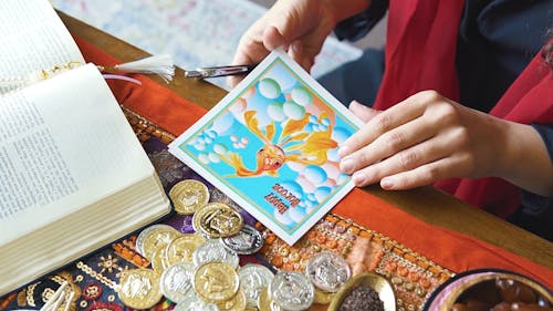 A Woman Writing A New Year Greeting Card