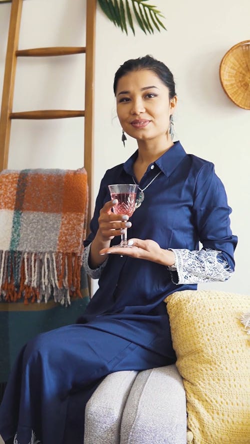A Woman With A Glass Of Red Wine On Hand