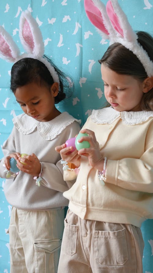 Little Girls Holding Easter Eggs