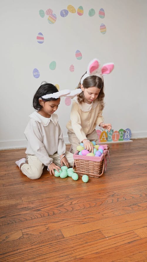 Girls Playing with Colored Eggs from a Basket