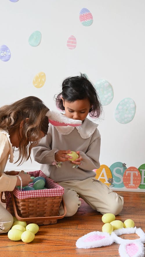 Girls Playing with Colored Eggs from a Basket