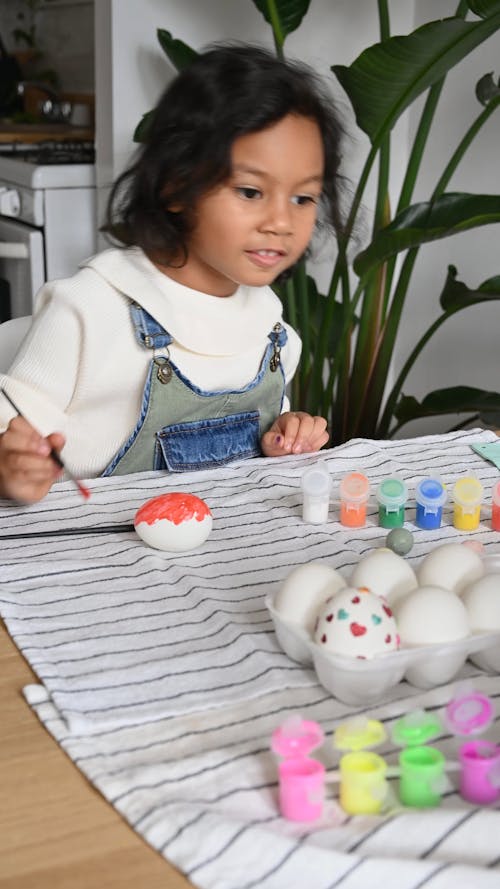 Girl Coloring an Easter Egg