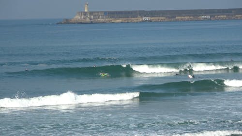 Surfers Riding the Waves