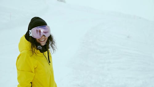 A Female Snowboarder Riding Downhill