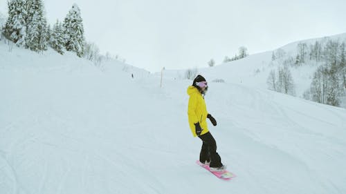 A Person Snowboarding Downhill