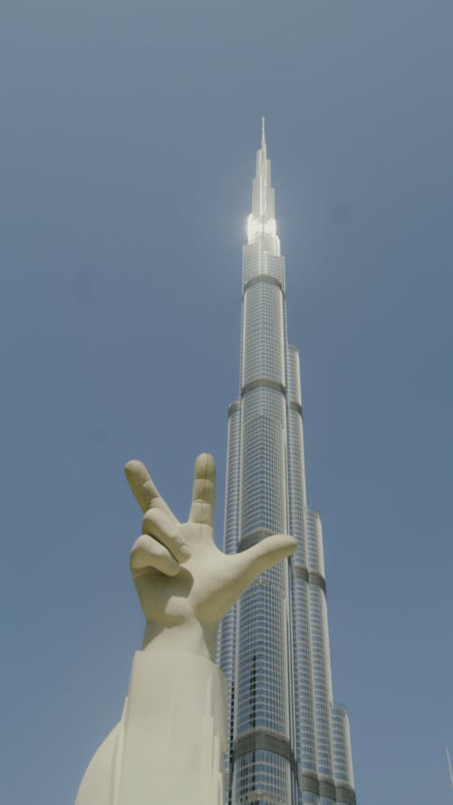 Low Angle Shot of a Sculpture and the Burj Khalifa
