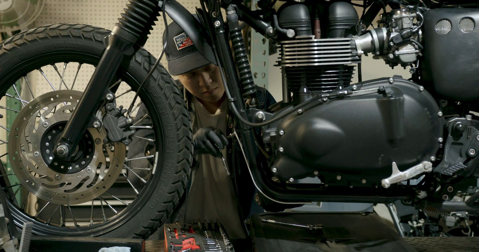 Mechanic working on a motorcycle in a workshop