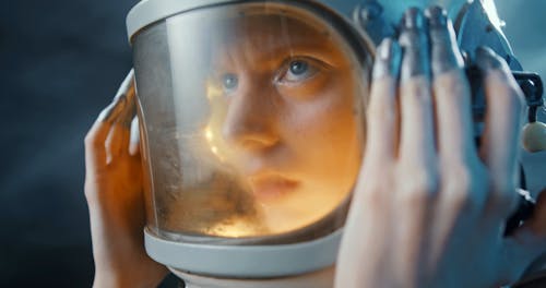 A Woman Opening The Cover Of Her Space Helmet