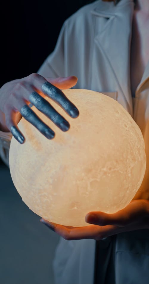 A Woman Holding A Glowing Sphere