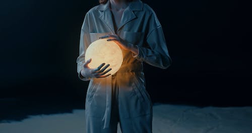 A Woman Holding A Glowing Ball