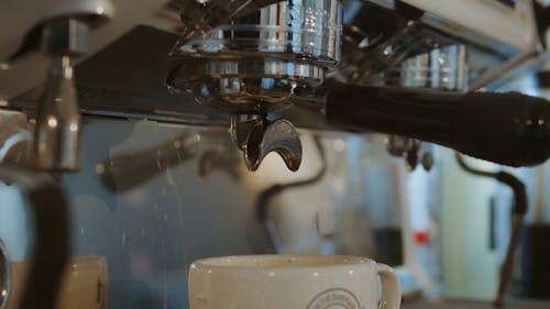 Drops Of Coffee Falling In A Mug