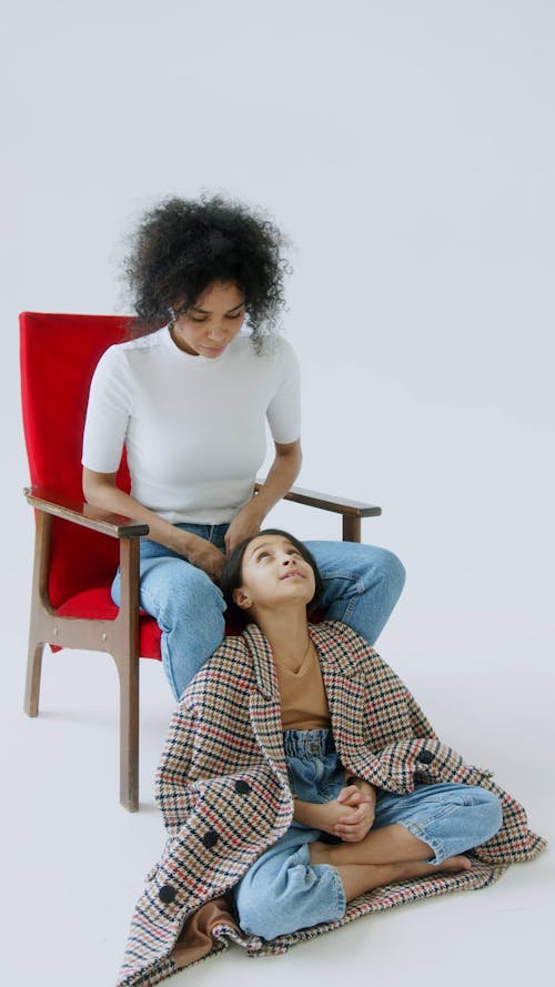 A Mother Tying Her Daughters Hair