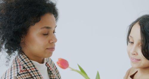 A Child Giving Her Mother a Flower