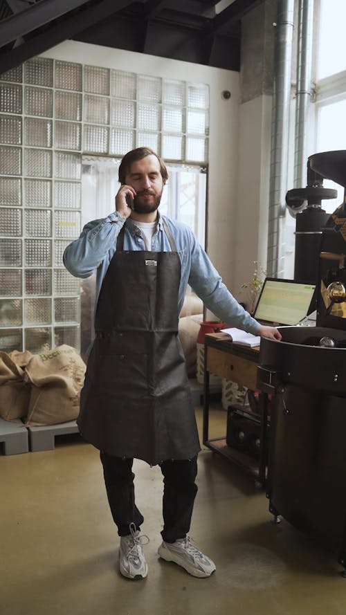 A Man Talking on the Phone While at Work