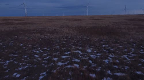 Drone Footage of Field with Windmills