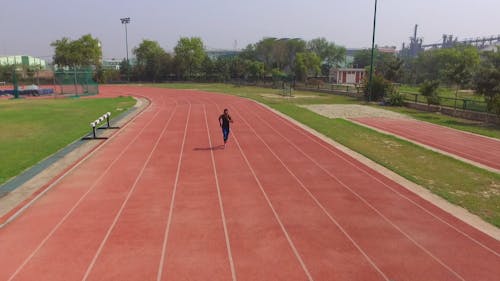 Aerial Shot of a Man Running on the Track