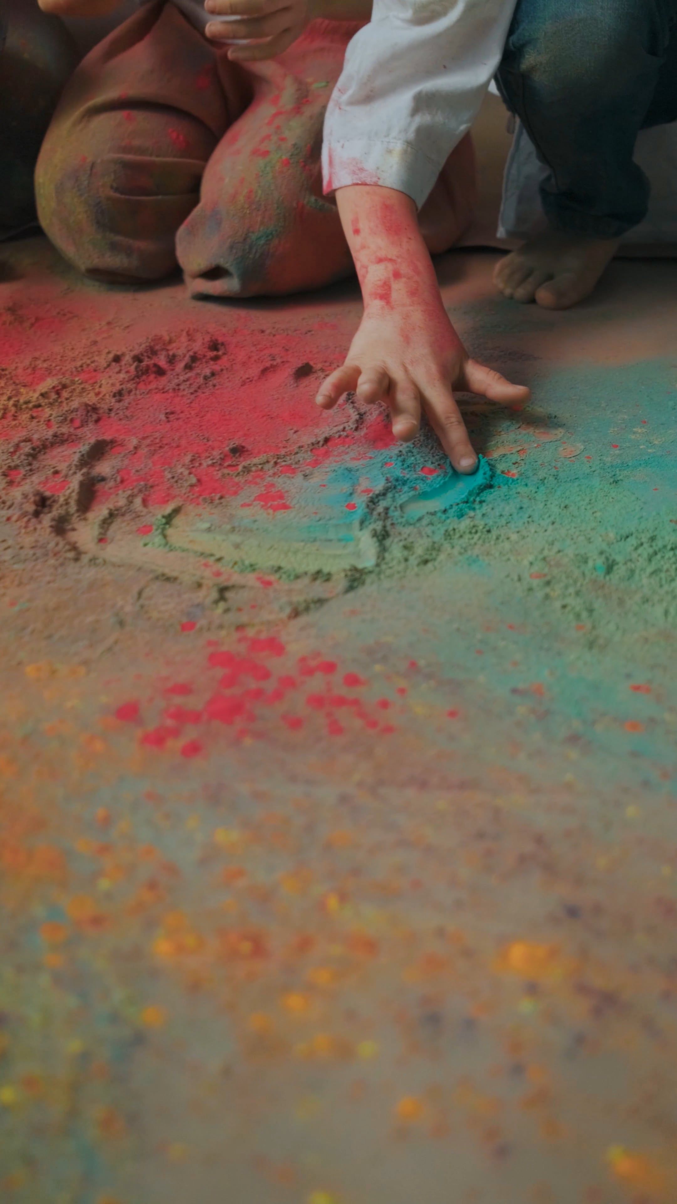 Close-up Footage of Touching the Colored Powder on the Floor Using His ...