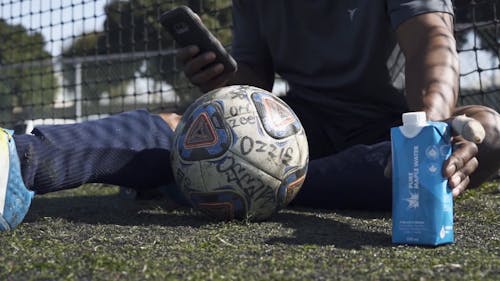 Low Angle Shot of a Man Drinking on the Soccer Field