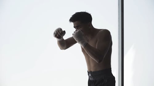 A Male Boxer Practicing His Punches