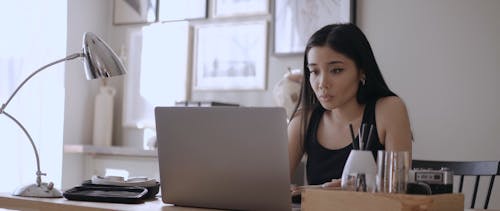 Woman Using Laptop at Home