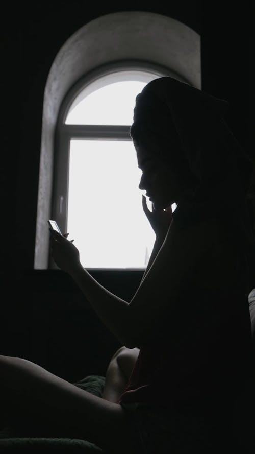 A Woman Applying a Skincare Product on Her Face