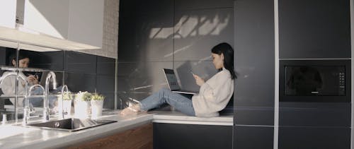 Woman Sitting on a Countertop