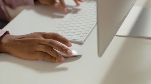 Close-Up View of a Person Using an iMac