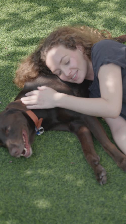 A Woman Petting Her Dog