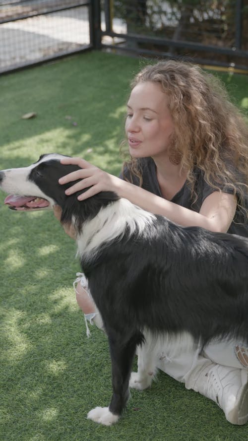 A Woman Petting Her Dog