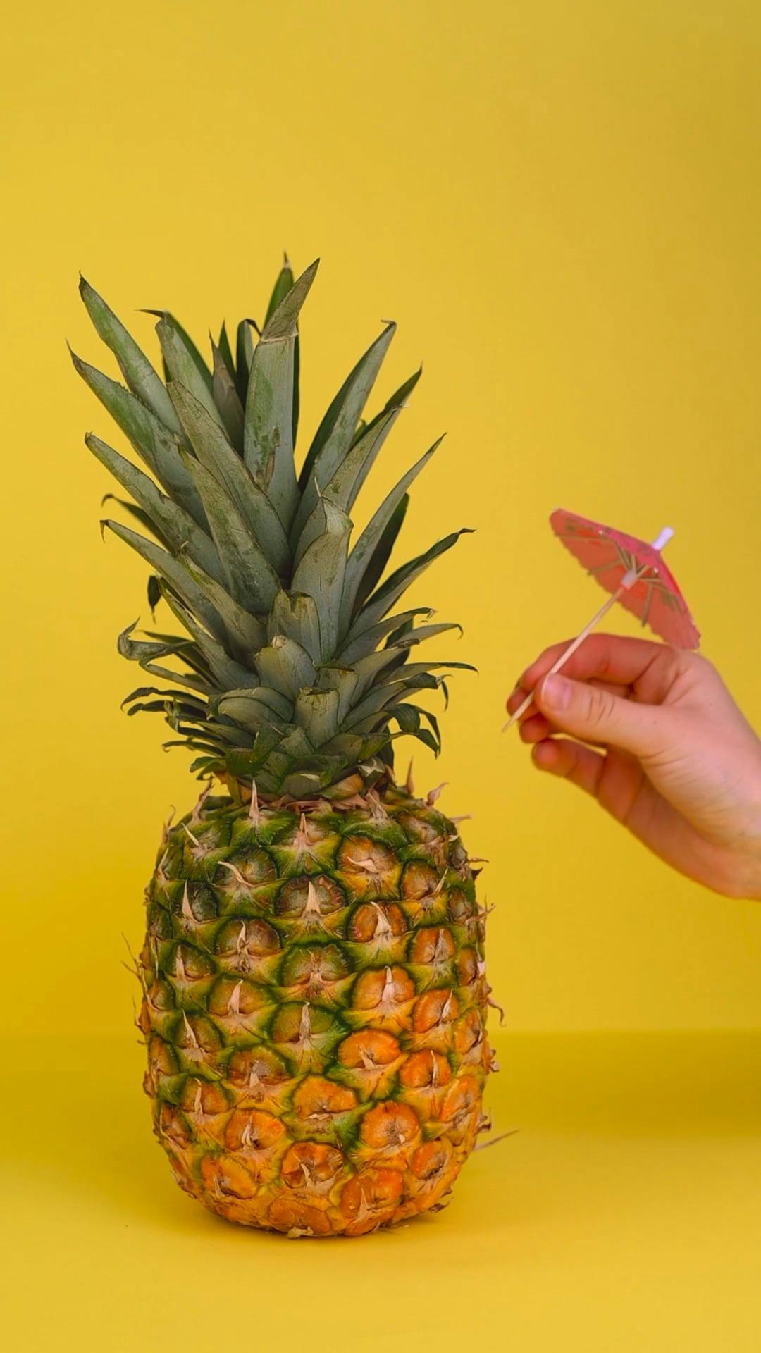 Sticking a Small Umbrella on a Pineapple · Free Stock Video