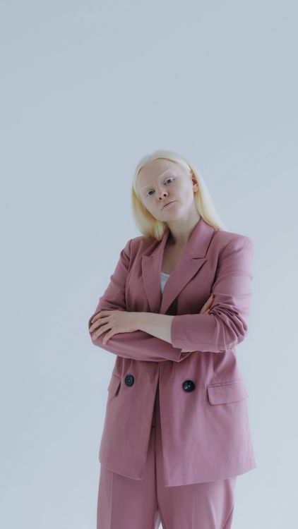 A Woman Fixing Her Blazer While Seriously Looking at Camera Free Stock ...