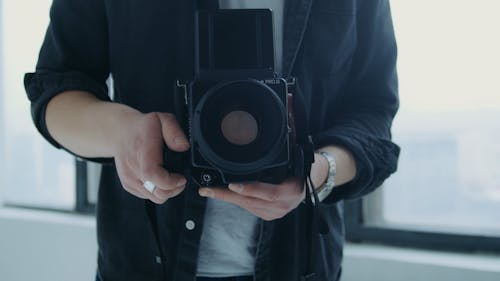 A Man Using A Professional Camera