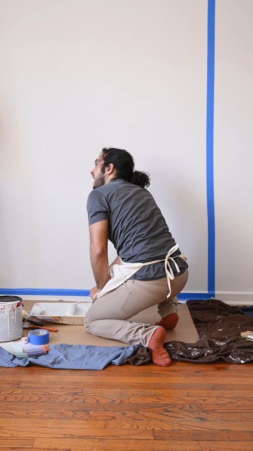 Man Painting Wall at Home