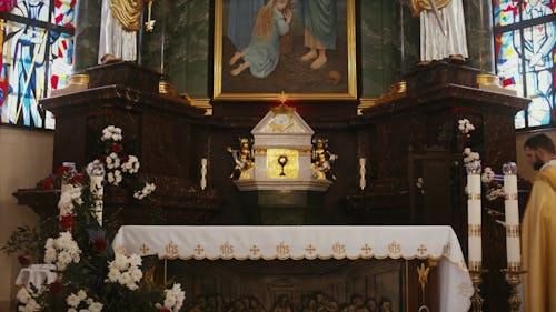 A Priest Preparing the Altar