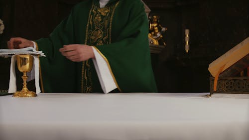 A Priest Preparing the Altar