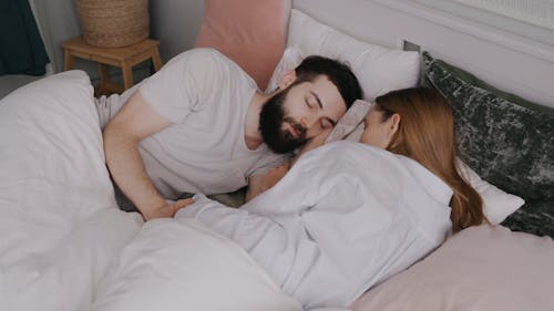 Couple Sleeping on Bed