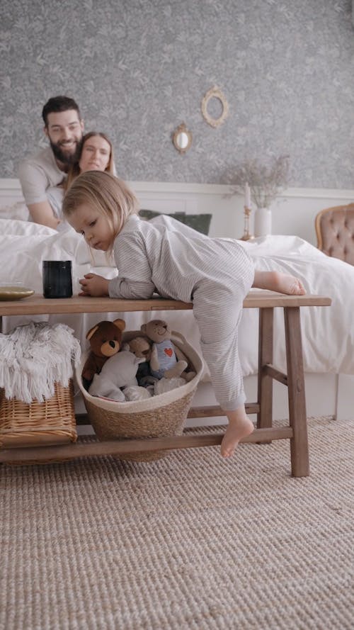 A Couple and their Baby Sitting Playing in the Bed