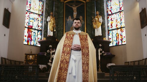 Priest Walking on Church Aisle