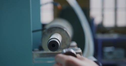 A Person Assembling a Machinery