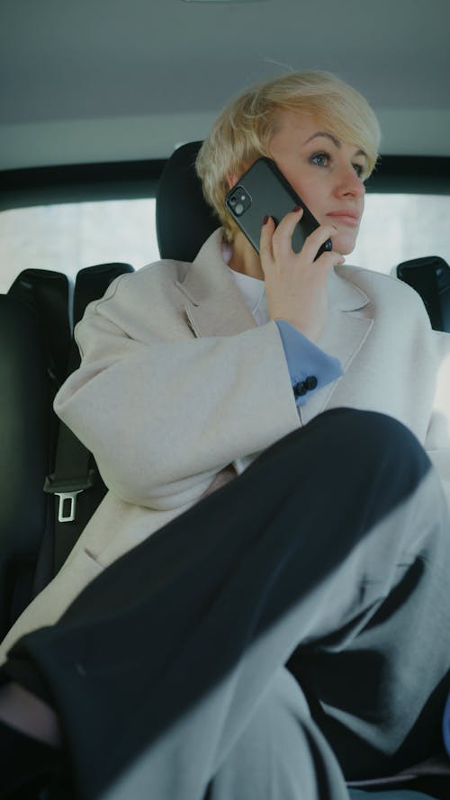 A Woman Talking on the Phone while Sitting in a Car
